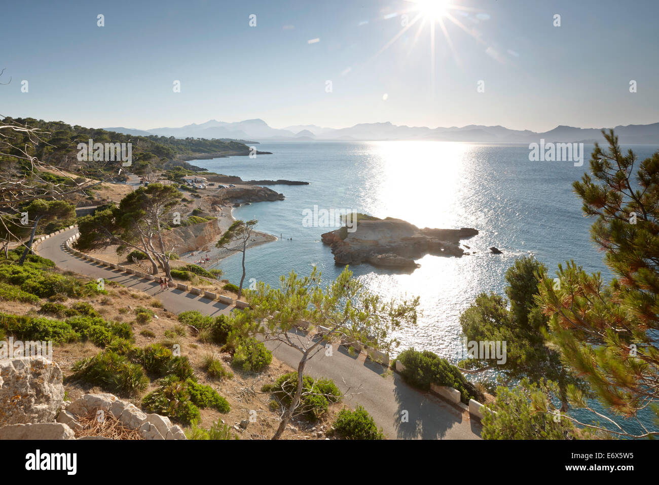 Coastal road leads to S'Illot chapel, view over Playa S'Illot beach, Alcudia peninsula, bay of Pollenca, Mallorca, Balearic Isla Stock Photo