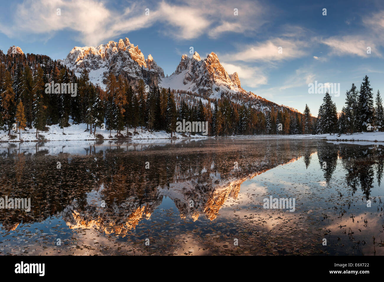 Picturesque sunset above the mirror-like Lago de Antorno with the numerous peaks of Cadini Misurina in the background, South Tyr Stock Photo