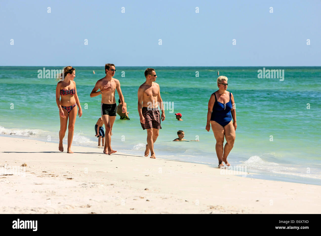 A family enjoy the sunshine of Florida on Anna Maria Island in