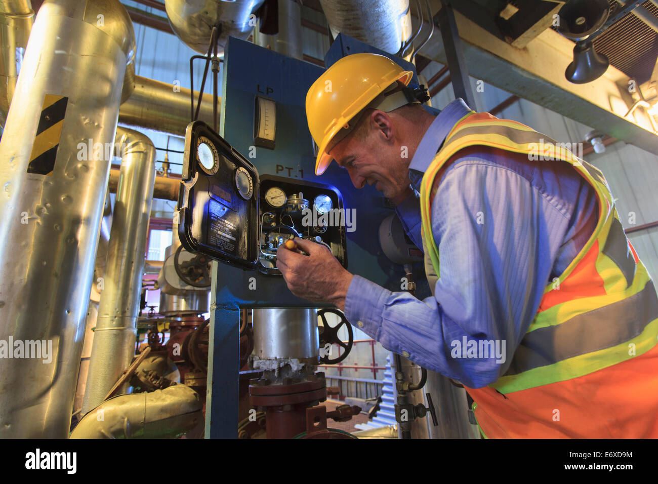 Engineer in electric power plant inspecting sensor Stock Photo - Alamy
