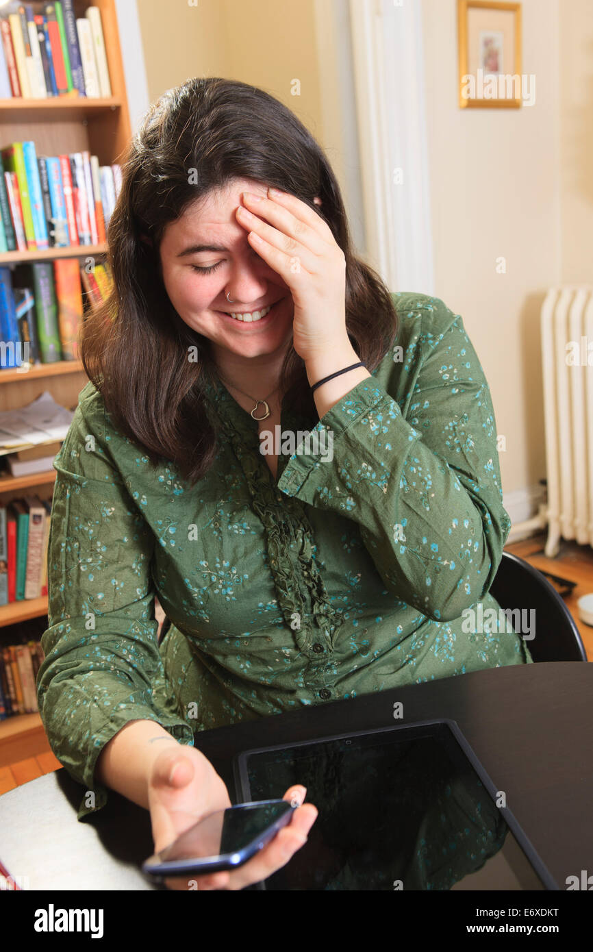 Woman with Asperger syndrome laughing at her text message Stock Photo ...