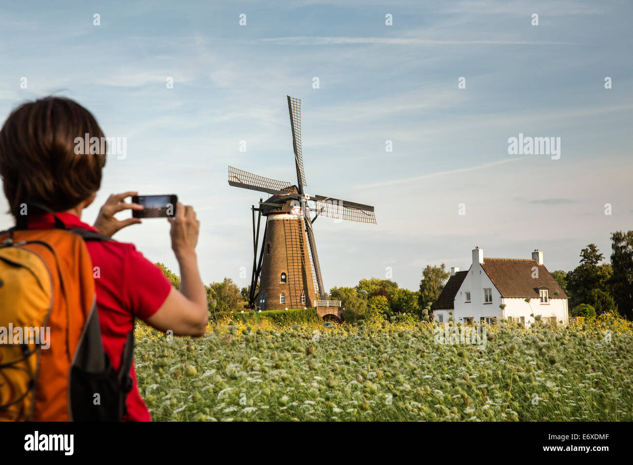 Netherlands, Nuenen, Village of Vincent van Gogh. Windmill De Roosdonck, which appears on 7 drawings. Hiker takes picture Stock Photo