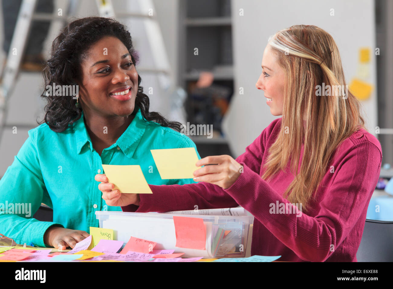 Engineering students reviewing brainstorming notes in lab Stock Photo