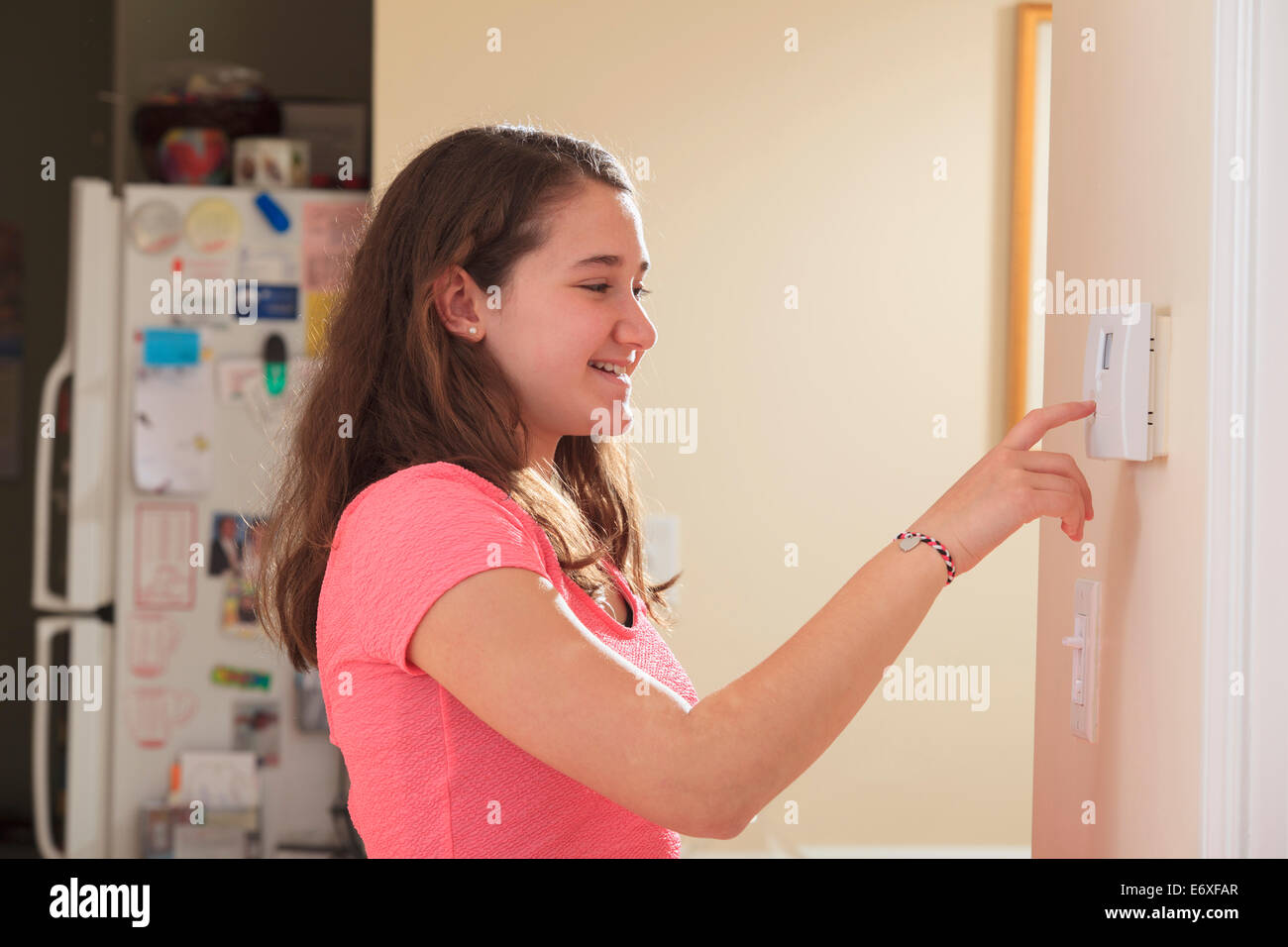 Teen girl setting home security system Stock Photo