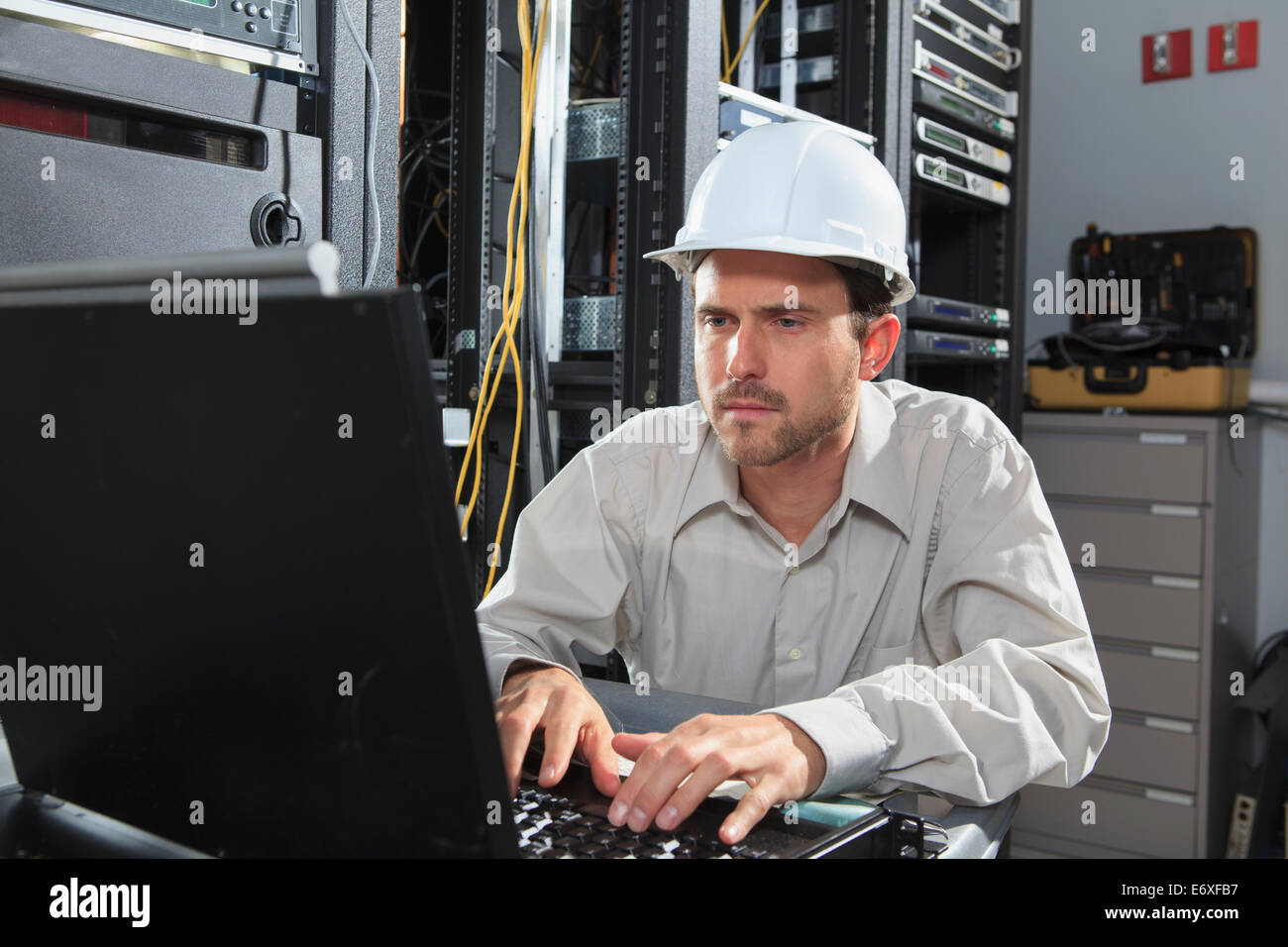 Network engineer at configuration laptop Stock Photo