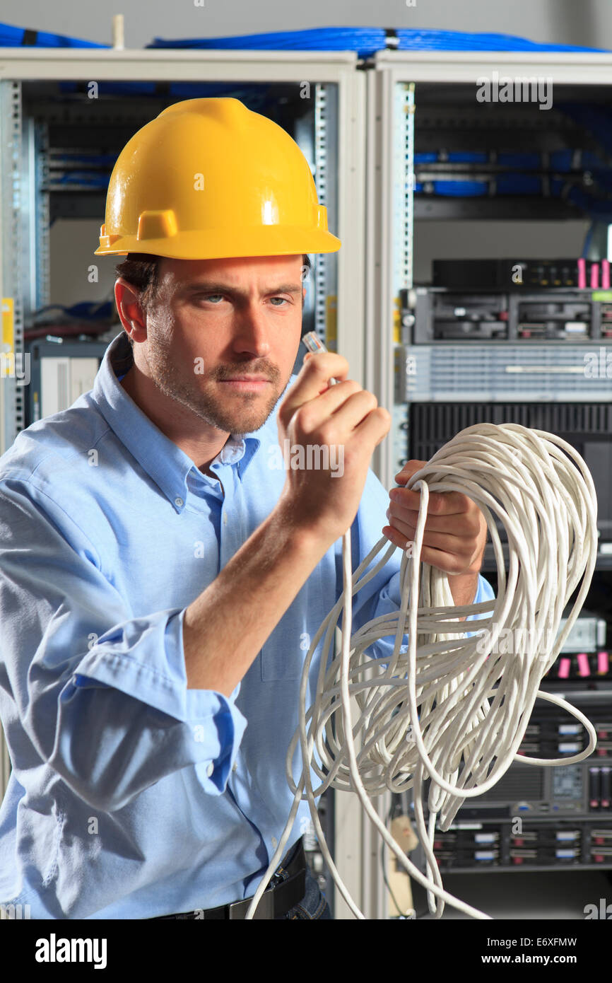 Network engineer examining cable crimp Stock Photo