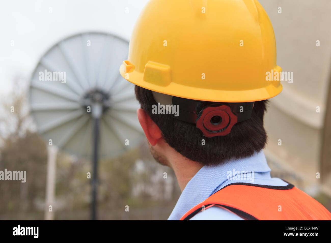 Communications engineer viewing satellite dish Stock Photo Alamy