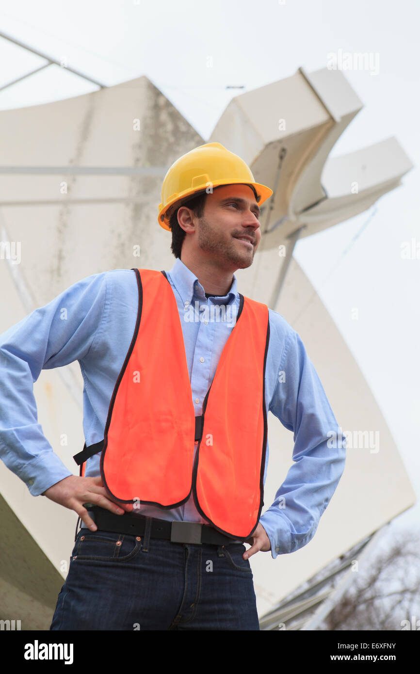 Communications engineer viewing satellite dish Stock Photo Alamy