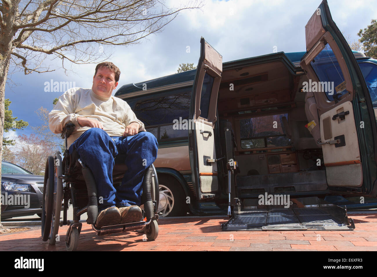 Man with Spinal Cord Injury opening his accessible van remotely Stock Photo
