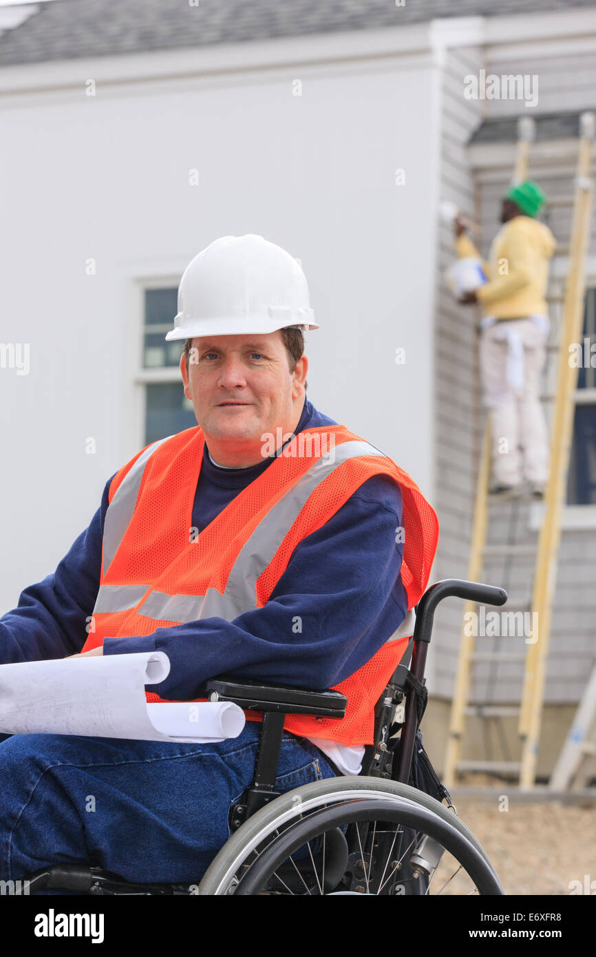 Construction engineer with spinal cord injury with house plans at ...