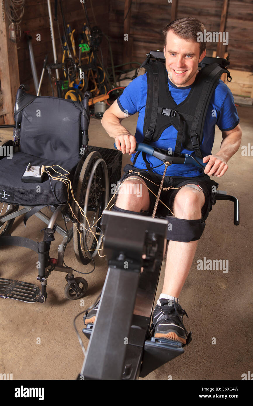 Man with spinal cord injury using his rowing machine with a muscle