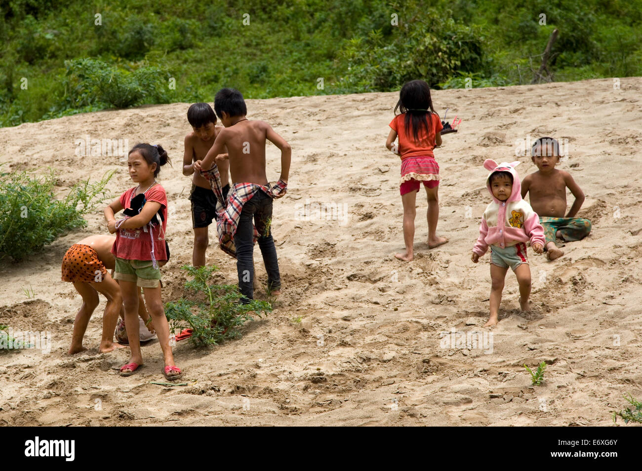 Children of a remote ethnic village playing on the bank of the Mekong ...