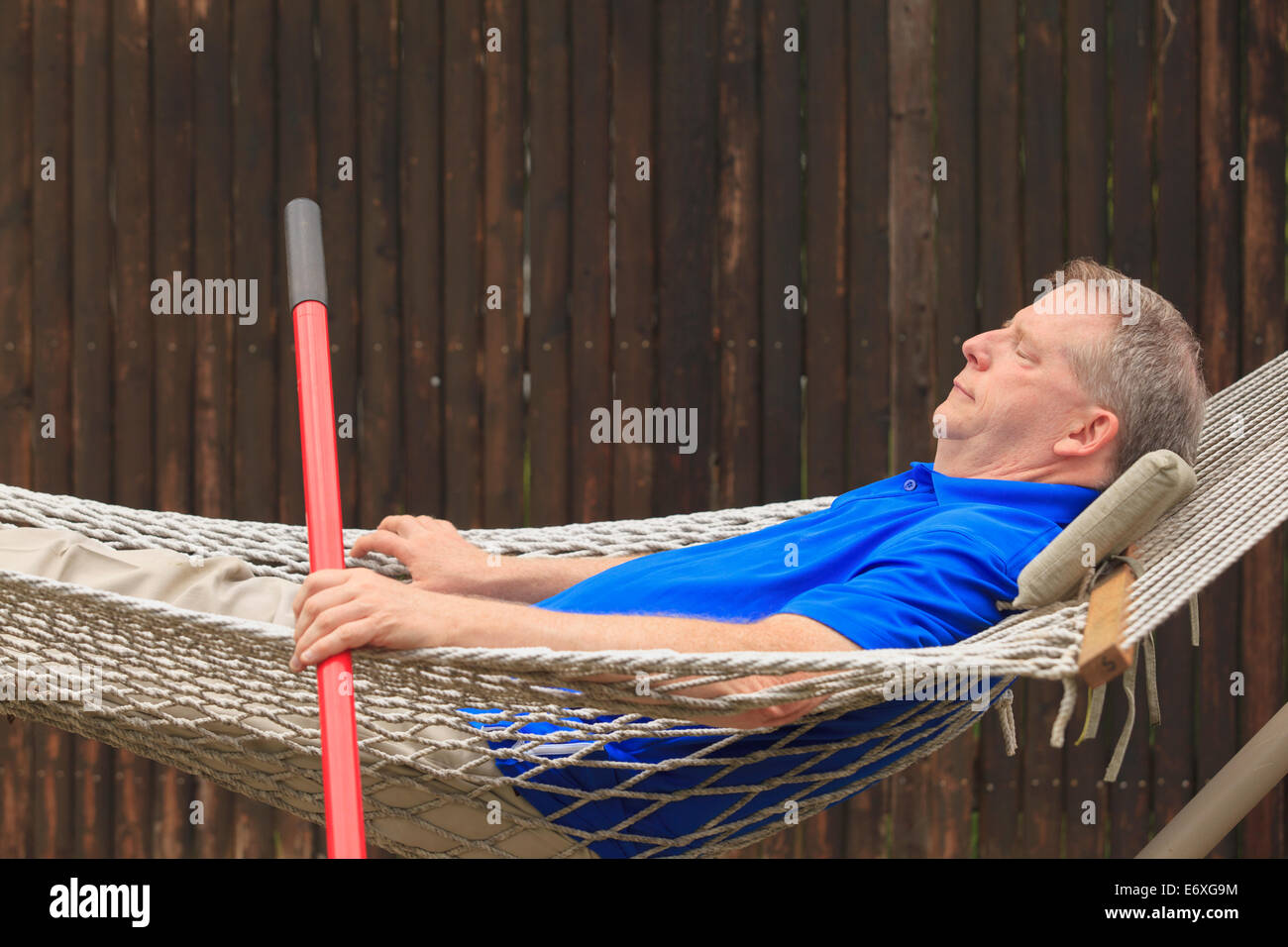 Man with Cerebral Palsy and dyslexia relaxing in his hammock Stock Photo