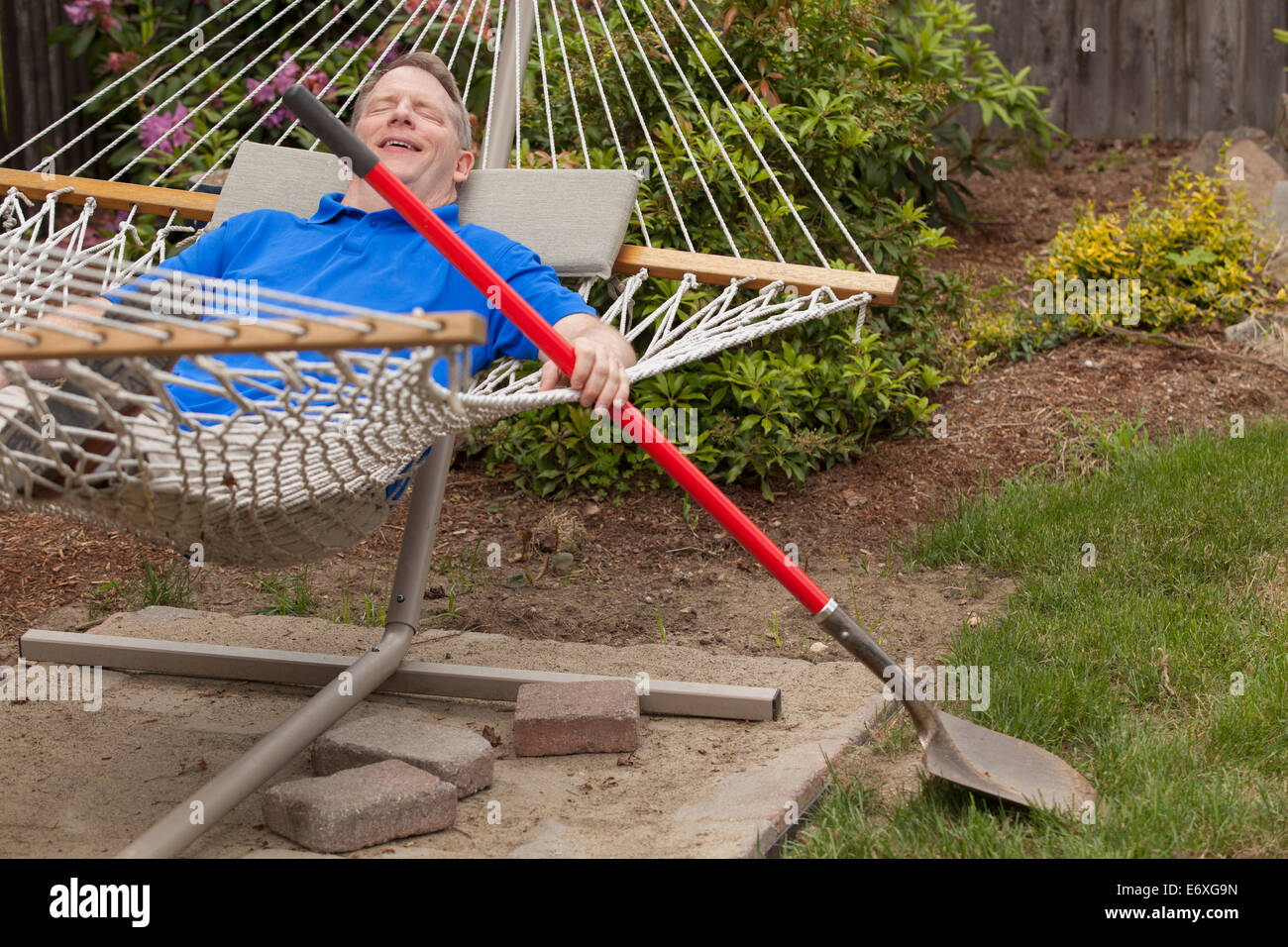 Man with Cerebral Palsy and dyslexia relaxing in his hammock Stock Photo