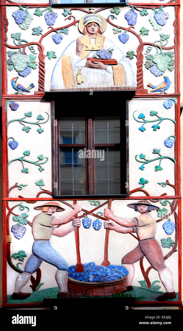 Innsbruck, Tirol, Austria. Painted facade of Gasthaus Weisses Kreuz (1465) showing grapes and wine-making. Facade decorations by Stock Photo