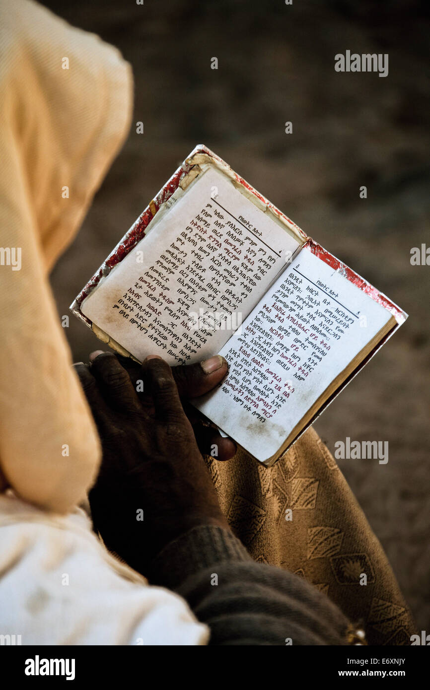 Pilgrim reading his prayer book, Lalibela, Ethiopia, Africa Stock Photo