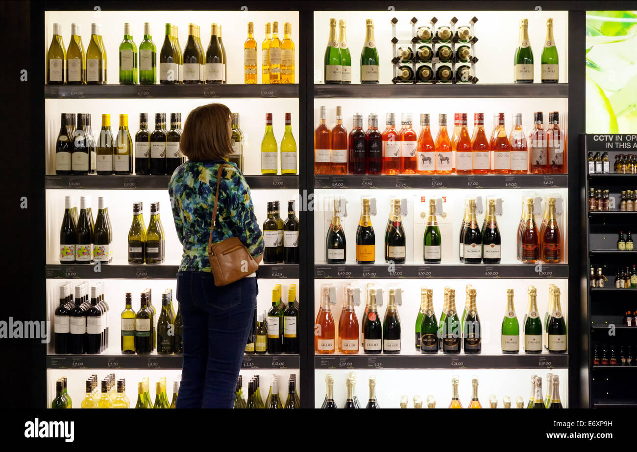 A woman buying wine , Downtown Superstore, Lincolnshire, England UK Stock Photo