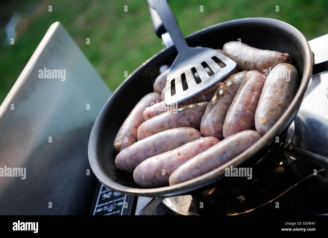 Sausages cooking in frying pan outdoors Stock Photo Alamy