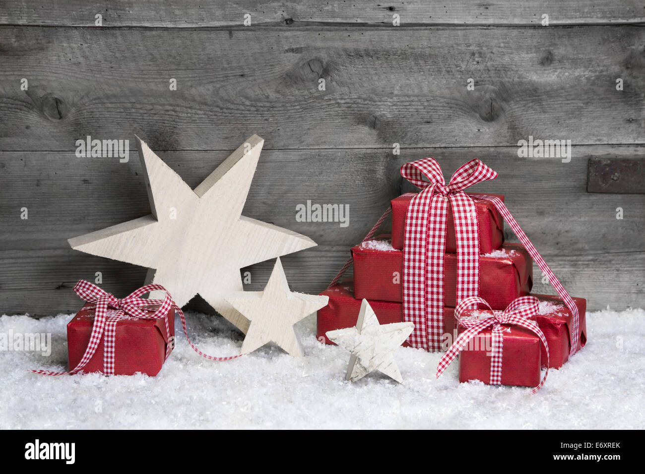 Vocher for christmas: wooden background with red presents and checked ribbon Stock Photo