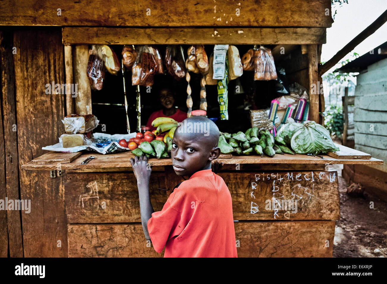 Boy in front of a food shop, Buwenda, Uganda, Africa Stock Photo