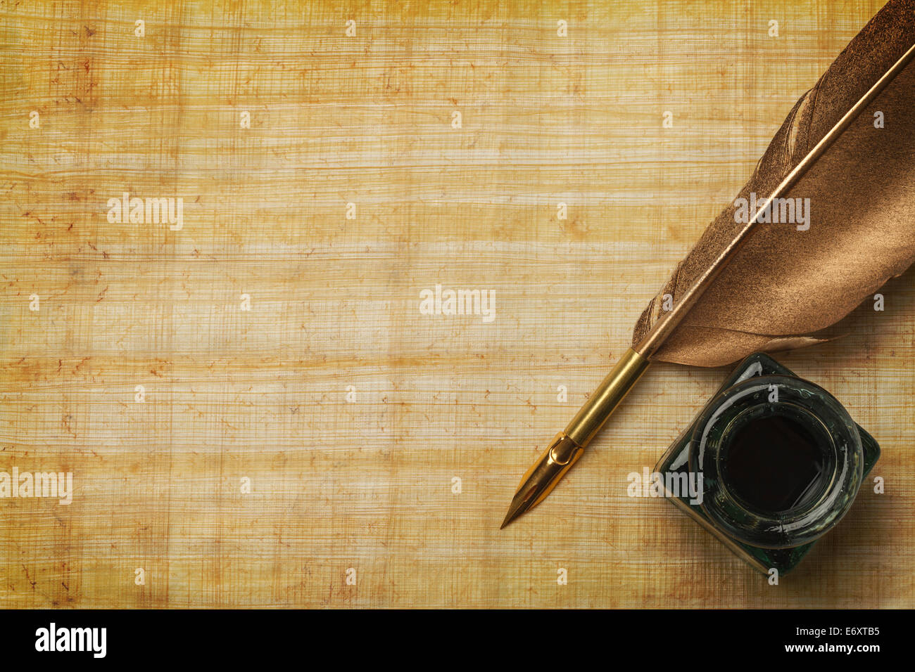 Old Paper and Feather Quill with Glass Ink Bottle and Copy Space. Stock Photo