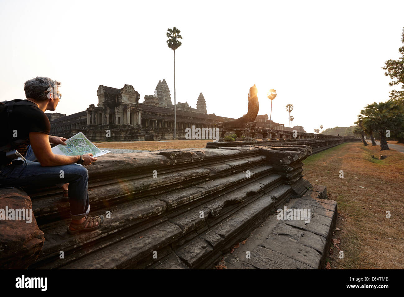 Visitor sitting on stairs, Angkor Wat temple, Angkor Archaeological Park, Siem Reap, Cambodia Stock Photo