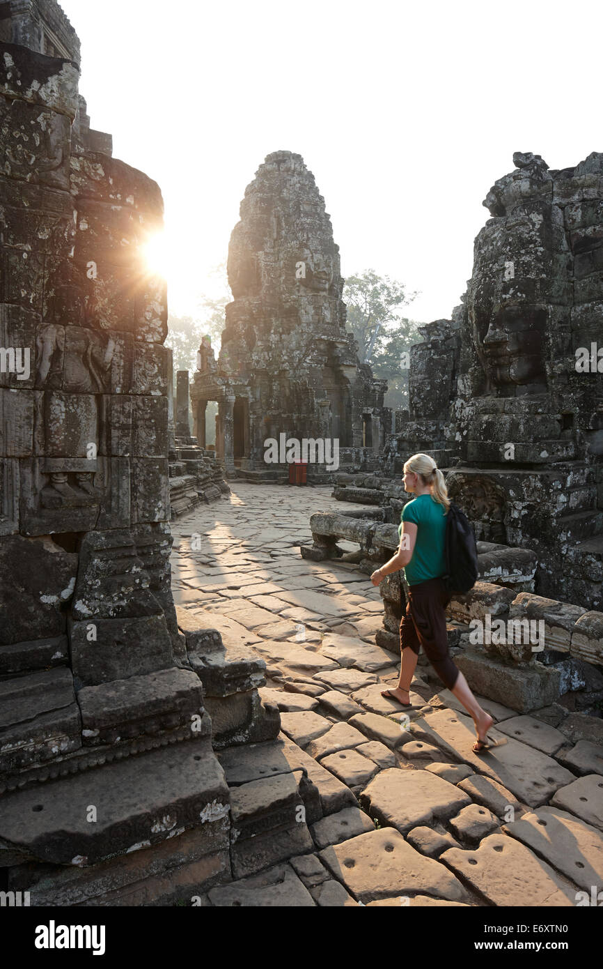 Woman visiting Bayon Temple, Angkor Archaeological Park, Siem Reap, Cambodia Stock Photo