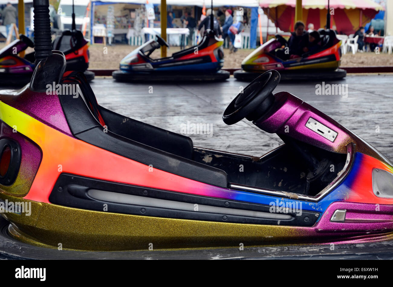 People enjoying bumper cars also known as bumping cars, dashing cars