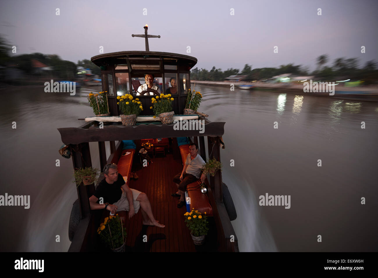 Crew and guests on a houseboat on Mekong river, near Long Xuyen, An Giang Province, Vietnam Stock Photo