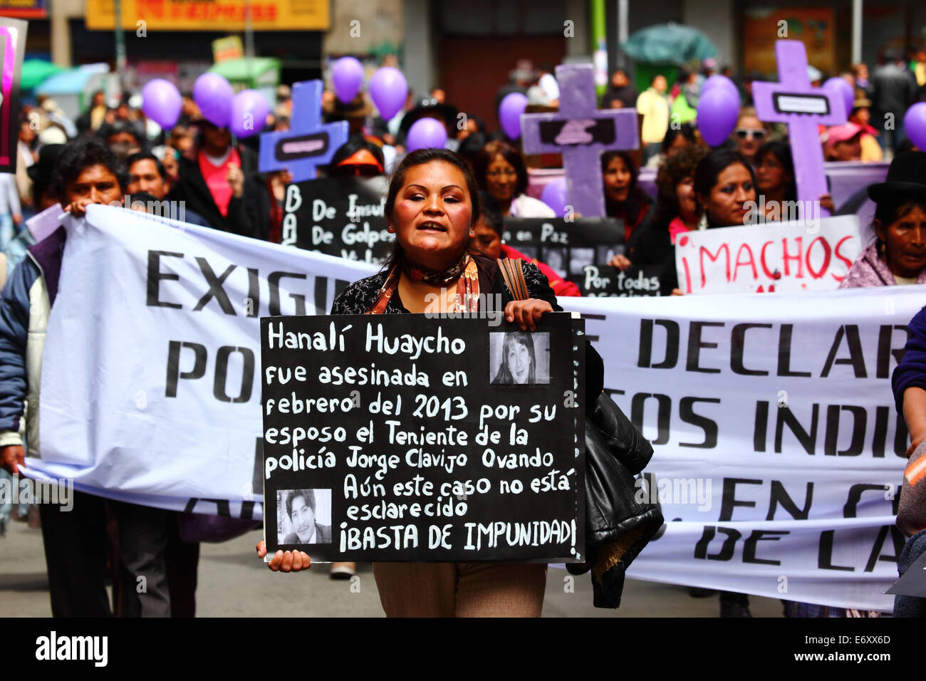 La Paz, Bolivia, 1st September 2014. A Womens Rights activist carries a placard remembering Hanali Huaycho during a march to protest against violence against women. The march was also repudiate recent statements made by several candidates during the current election campaign that appear to minimise the problem and discriminate against women. According to a WHO report in January 2013 Bolivia is the country with the highest rate of violence against women in Latin America, there have been 453 cases of femicide since 2006 during the current government. Credit:  James Brunker/Alamy Live News Stock Photo