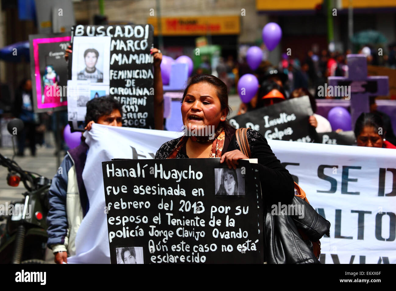 La Paz, Bolivia, 1st September 2014. A Womens Rights activist carries a placard remembering Hanali Huaycho during a march to protest against violence against women. The march was also to repudiate recent statements made by several candidates during the current election campaign that appear to minimise the problem and discriminate against women. According to a WHO report in January 2013 Bolivia is the country with the highest rate of violence against women in Latin America, there have been 453 cases of femicide since 2006 during the current government. Credit: James Brunker/Alamy Live News Stock Photo