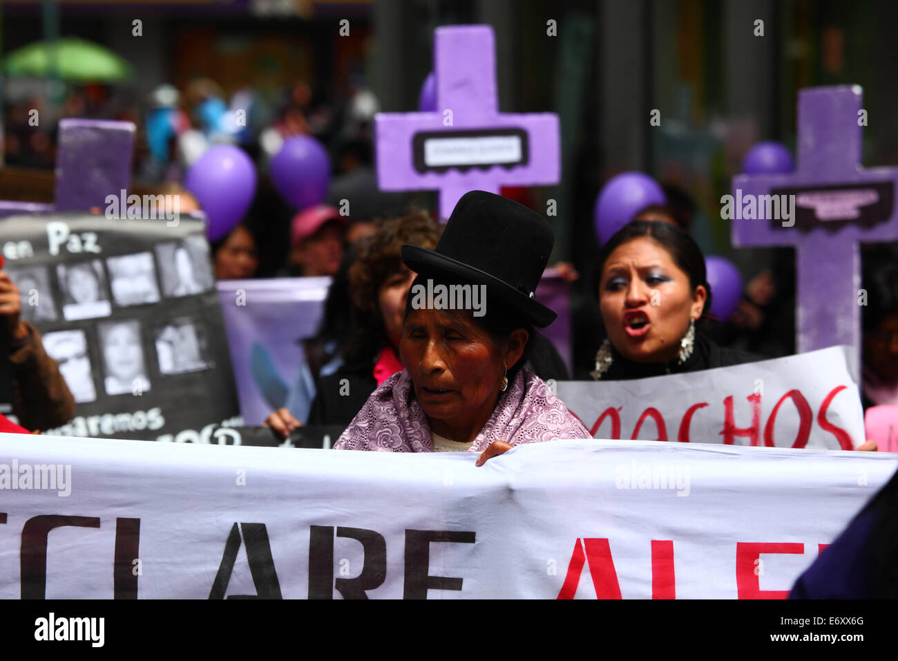 La Paz, Bolivia, 1st September 2014. Womens Rights Activists and supporters carry crosses with the names of victims during a march to protest against violence against women. The march was also to repudiate recent statements made by several candidates during the current election campaign that appear to minimise the problem and discriminate against women. According to a WHO report in January 2013 Bolivia is the country with the highest rate of violence against women in Latin America, there have been 453 cases of femicide since 2006 during the current government. Credit:  James Brunker/Alamy Live Stock Photo