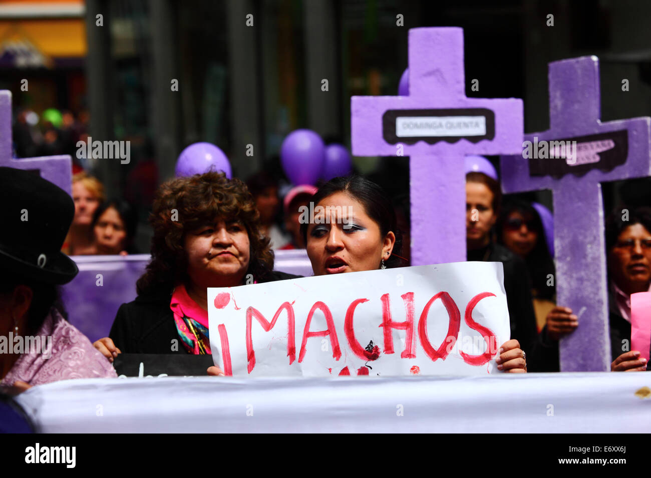 La Paz, Bolivia, 1st September 2014. Womens Rights Activists and supporters carry crosses with the names of victims during a march to protest against violence against women. The march was also to repudiate recent statements made by several candidates during the current election campaign that appear to minimise the problem and discriminate against women. According to a WHO report in January 2013 Bolivia is the country with the highest rate of violence against women in Latin America, there have been 453 cases of femicide since 2006 during the current government. Credit:  James Brunker/Alamy Live Stock Photo