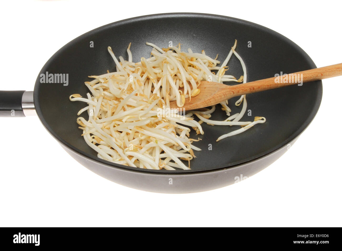 Raw bean sprouts in a wok with a wooden spoon isolated against white Stock Photo