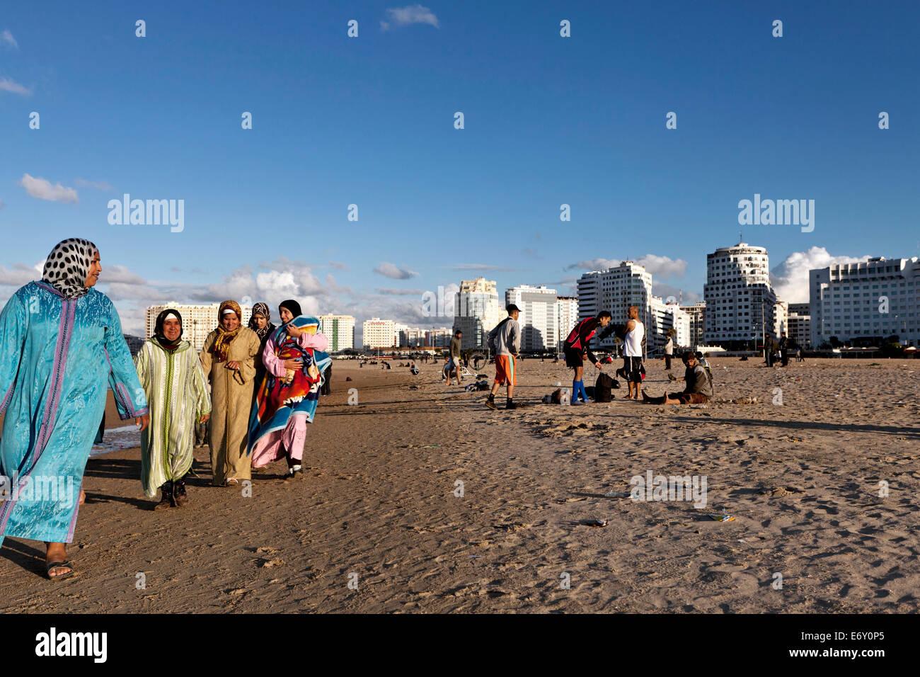 Moroccan women walking along the shore, Tangiers, Morocco Stock Photo