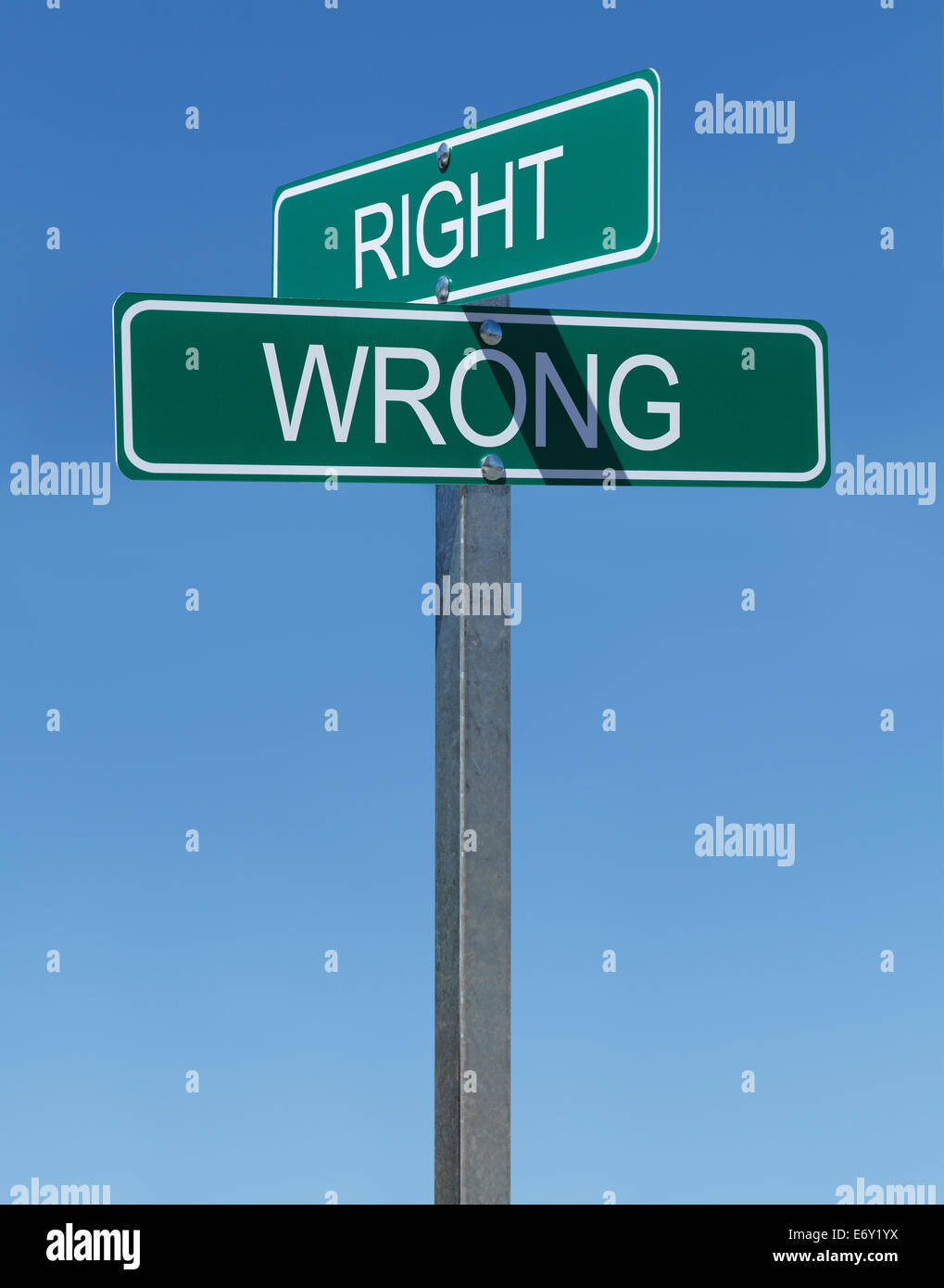 Two Green Street Signs Right and Wrong on Metal Pole with Blue Sky Background. Stock Photo