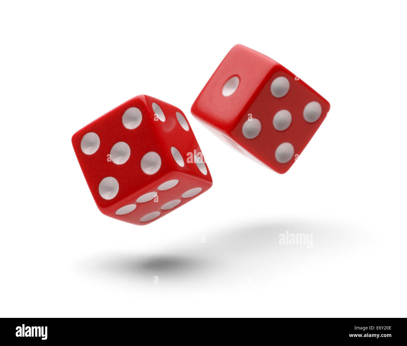 Red Dice in Air Rolling with Shadows Isolated on White Background. Stock Photo