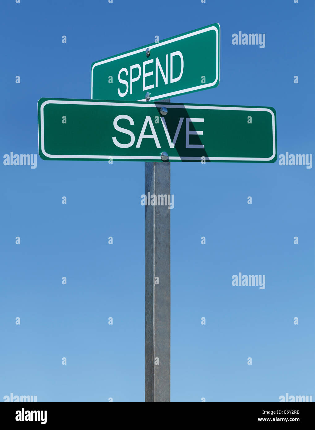 Two Green Street Signs Spend and Save on Metal Pole with Blue Sky Background. Stock Photo