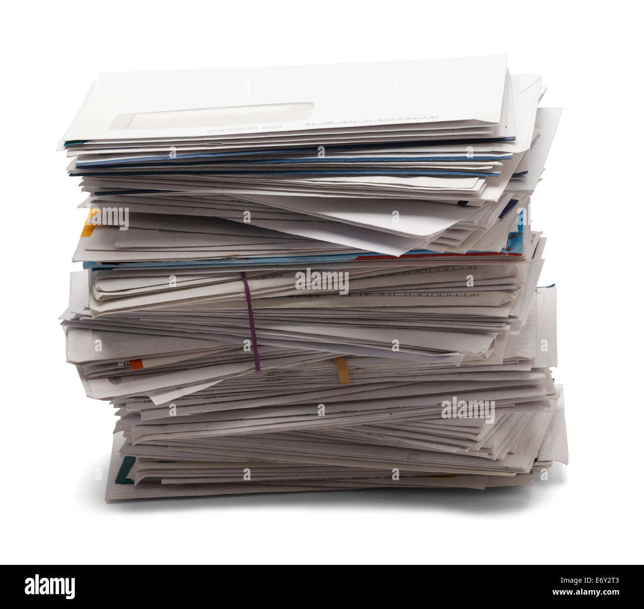 Junk mail stacked high of unpaid bills from the side view, isolated on a white background. Stock Photo