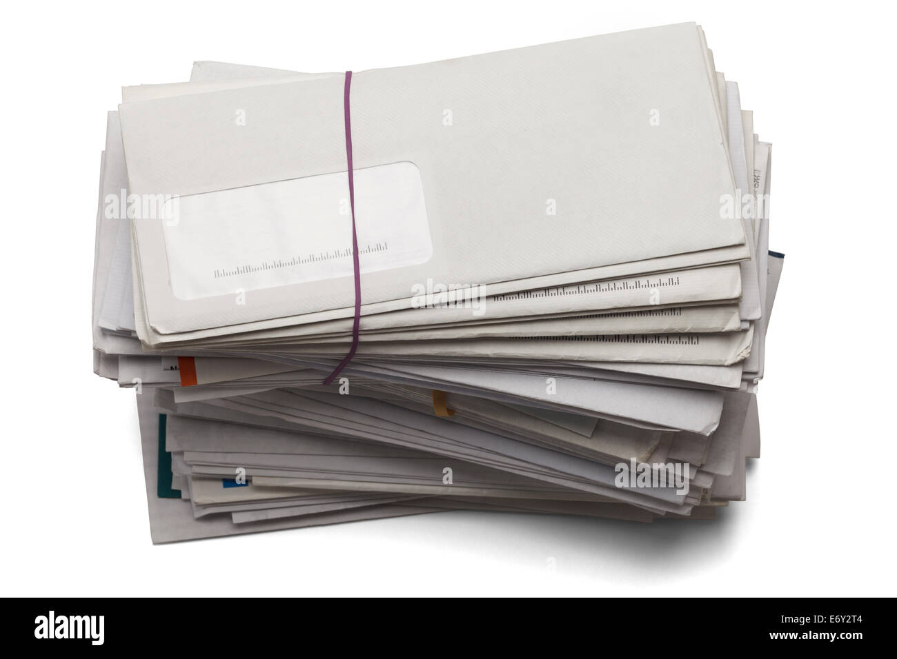 Mail stacked high of unpaid bills isolated on a white background. Stock Photo