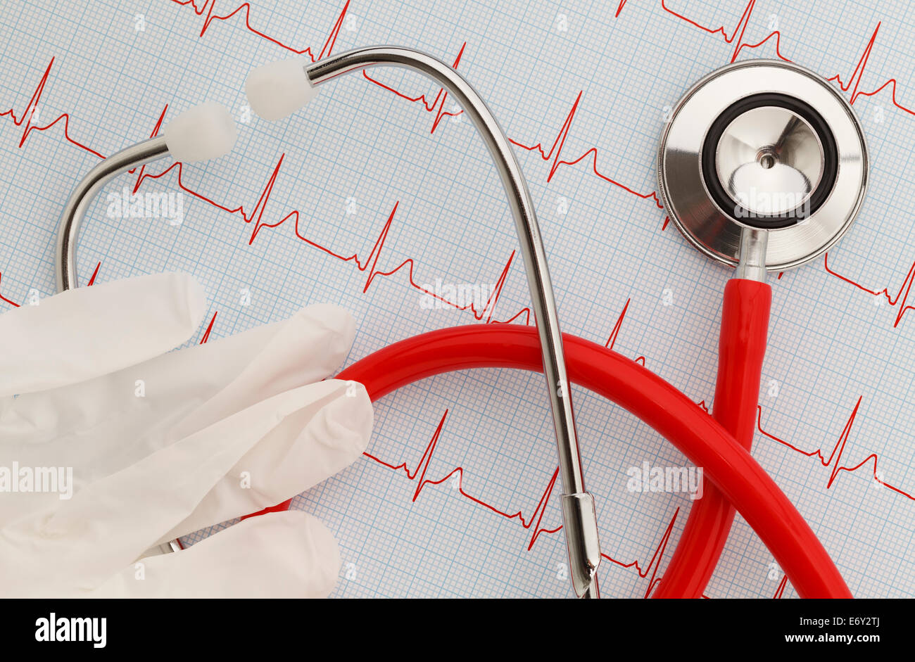 Stethoscope with an EKG readout and gloves. Stock Photo