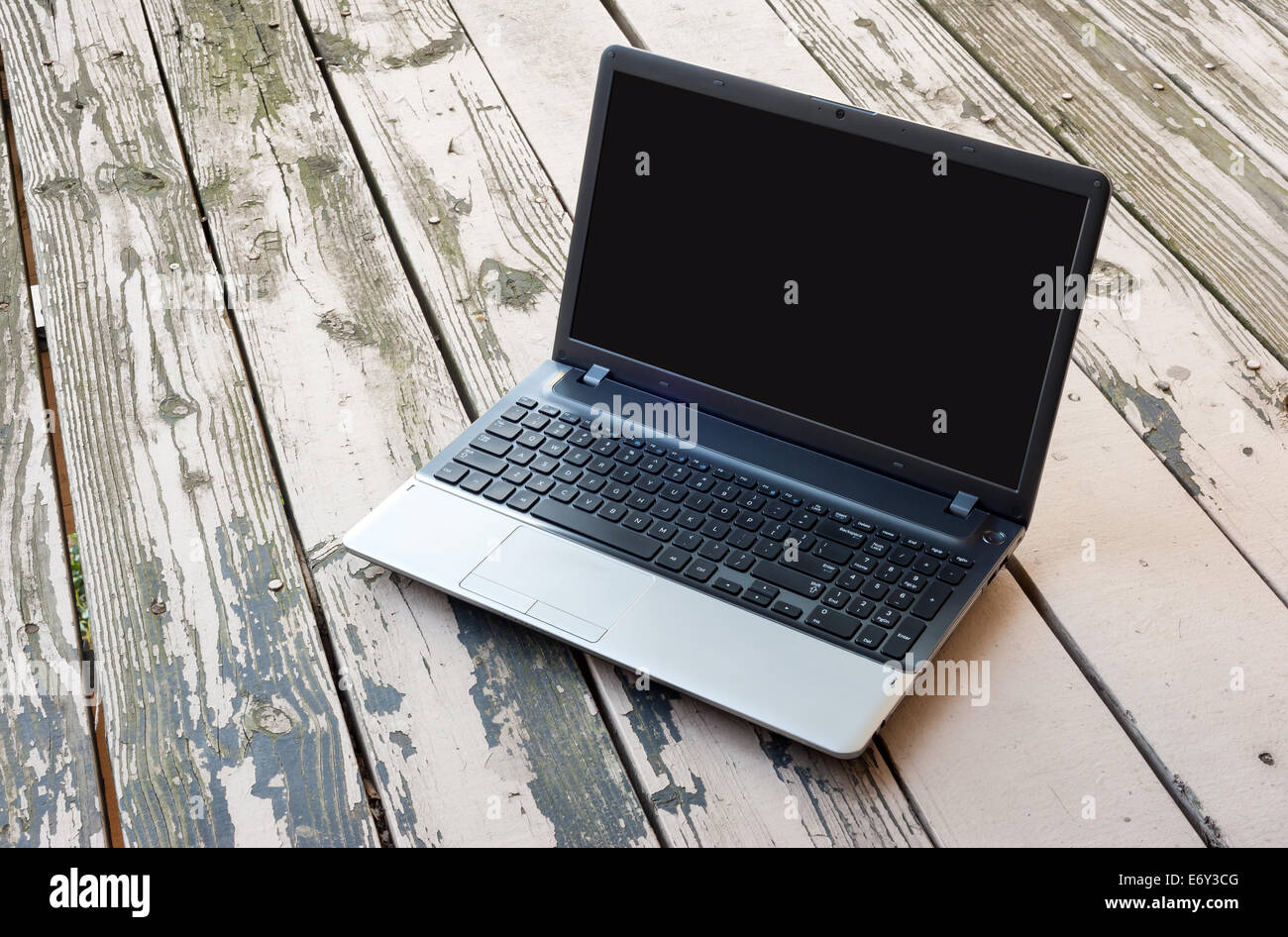 Laptop with black screen on the wooden table Stock Photo