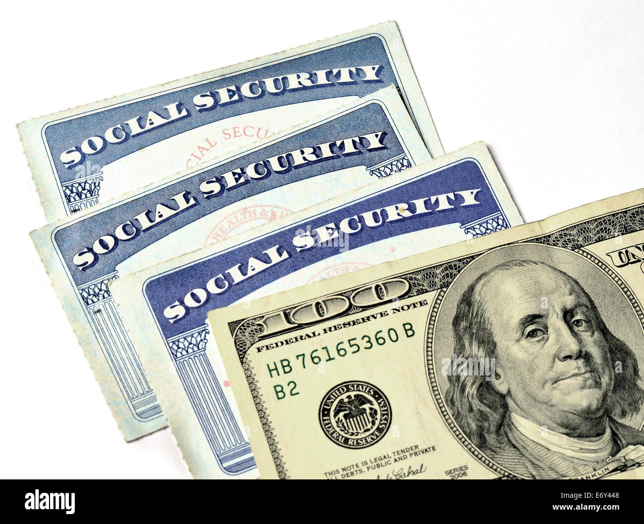 Detail of several Social Security Cards and cash money symbolizing retirement pensions financial safety Stock Photo