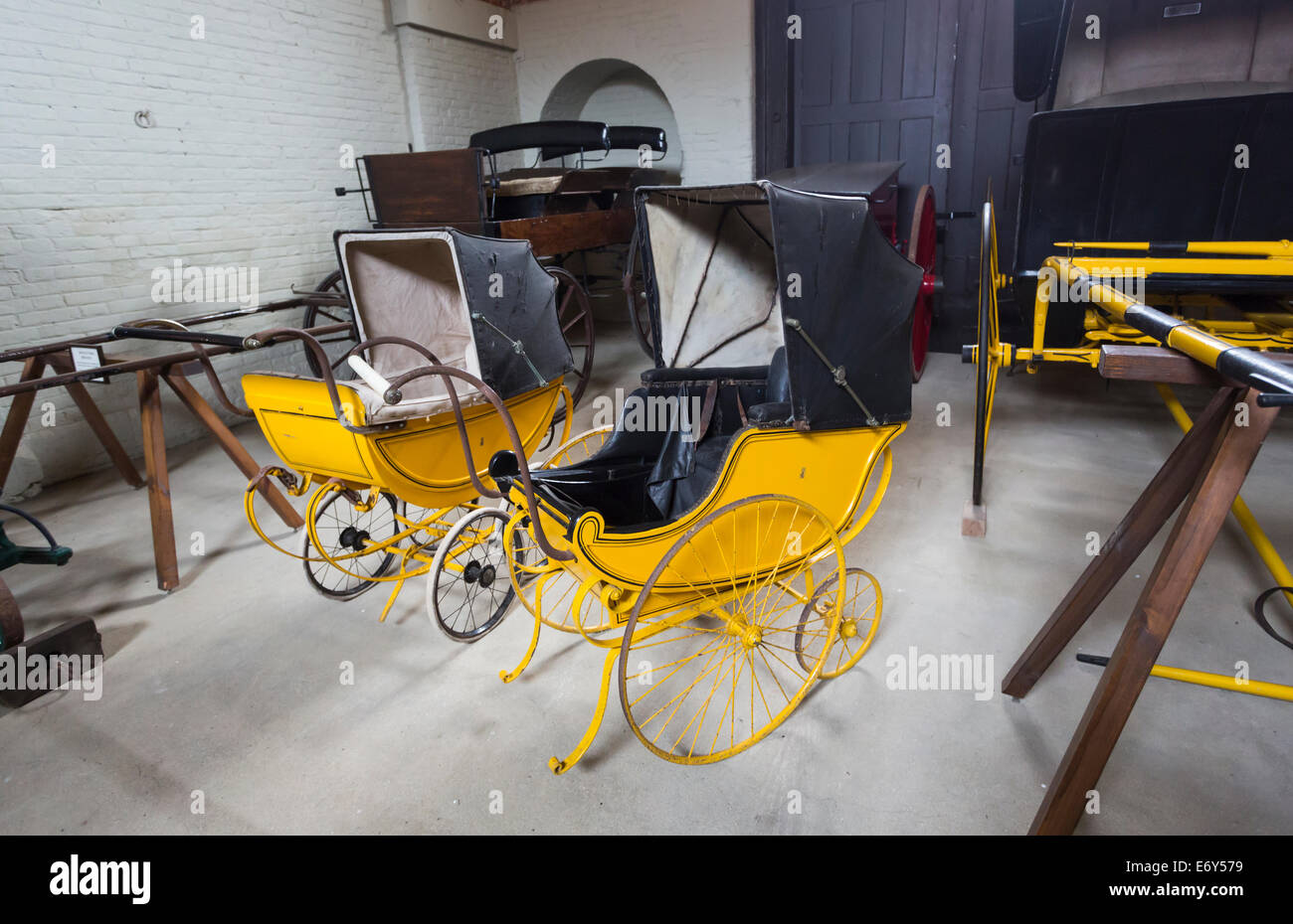 Vintage old yellow prams on display at Houghton Hall, north Norwich, UK Stock Photo