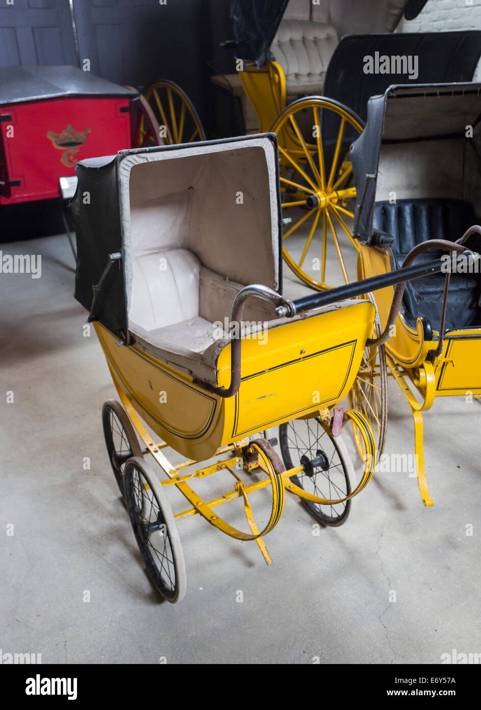 Vintage old yellow prams on display at Houghton Hall, north Norwich, UK Stock Photo