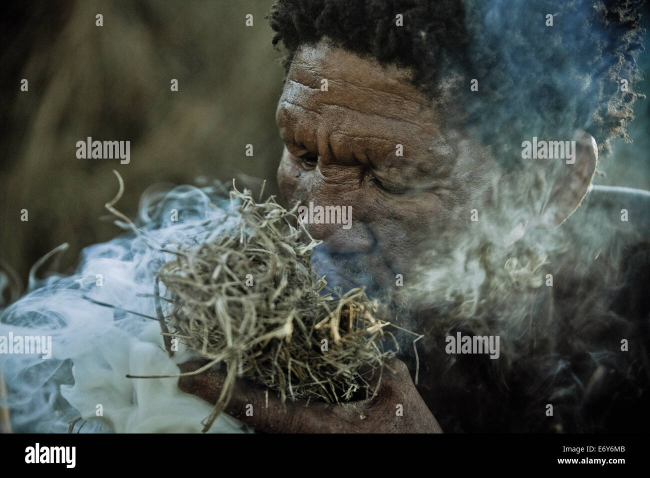 A man of the San tribe igniting a fire, Otjozondjupa region, Namibia, Africa Stock Photo