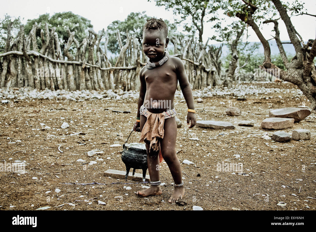 Child of the Himba tribe carrying a pot, Kaokoland, Namibia, Africa Stock Photo