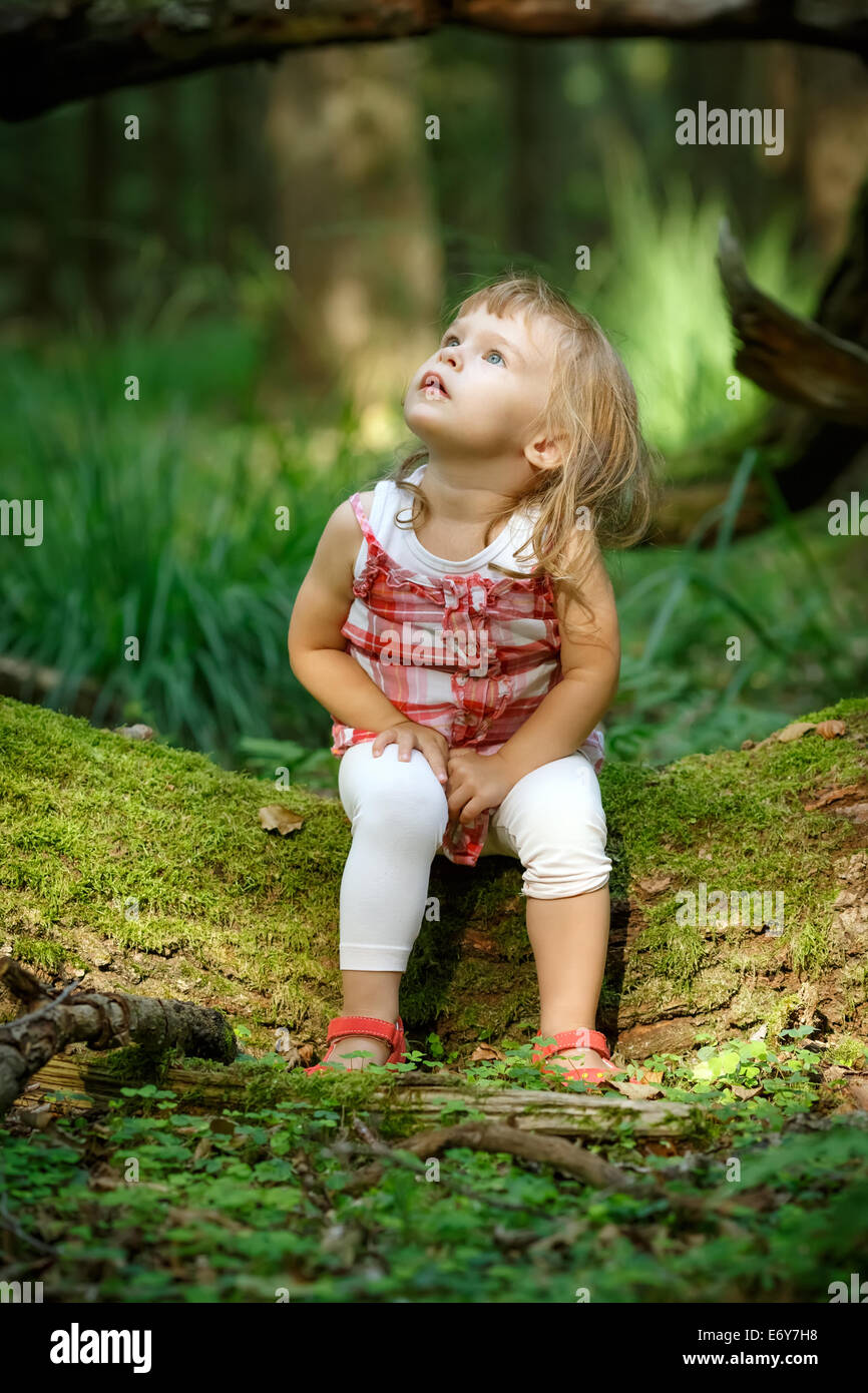Little girl in the forest Stock Photo - Alamy