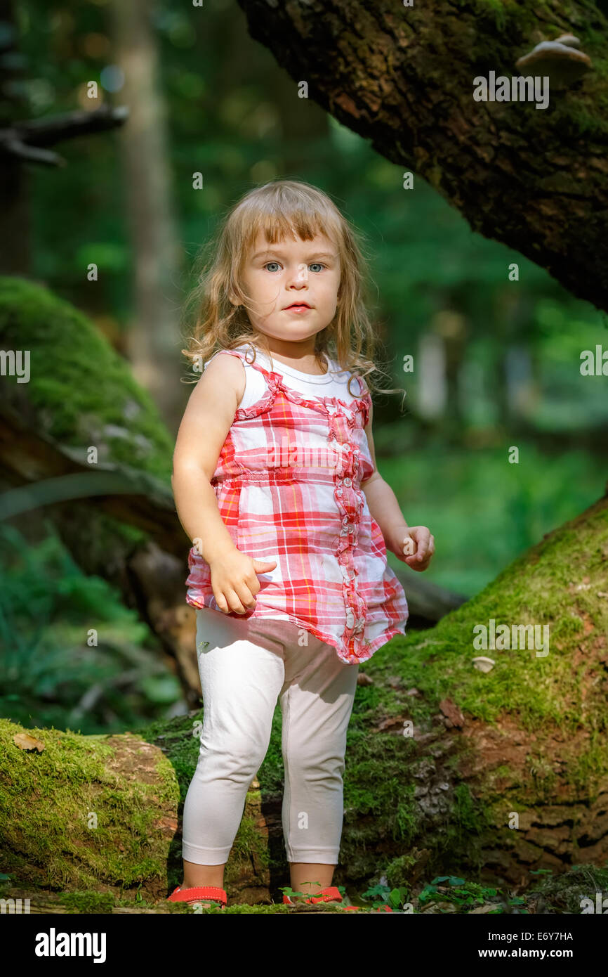 Little girl in the forest Stock Photo - Alamy