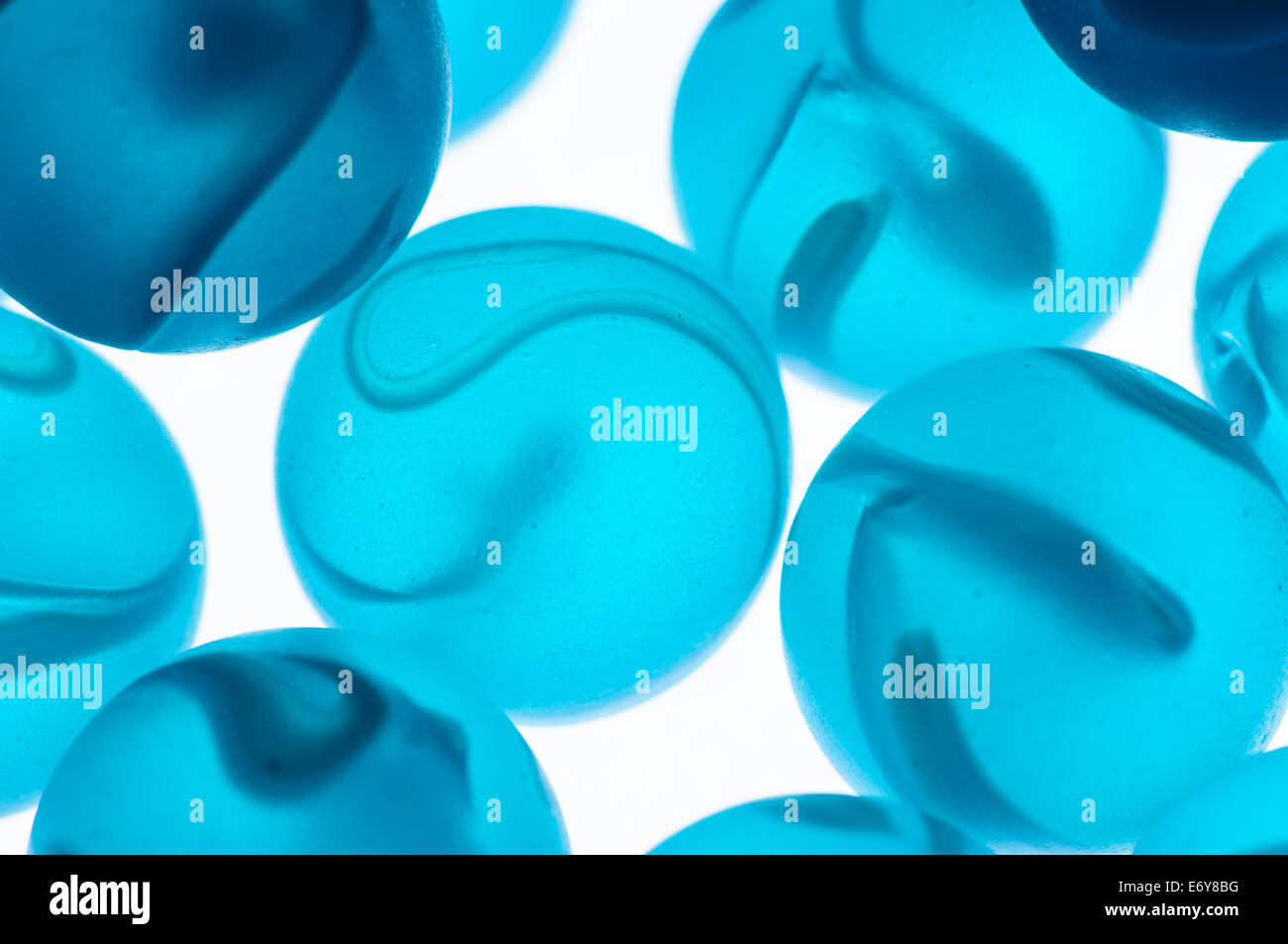 Close up of blue glass marbles on a white background Stock Photo